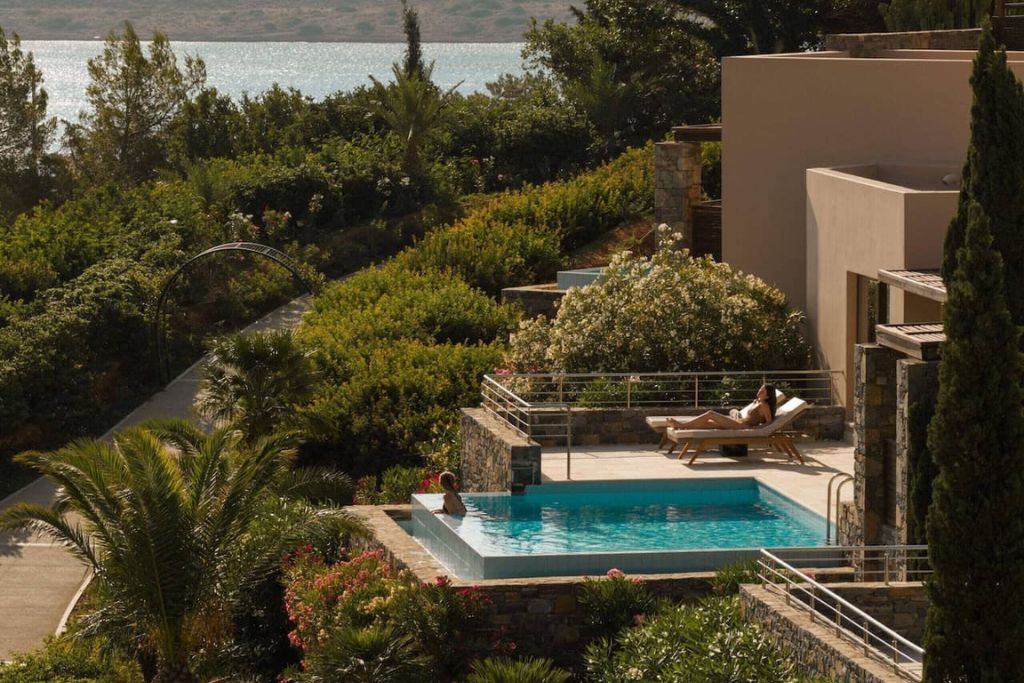 A woman lounging by the swimming pool outside the Phaea Blue Palace