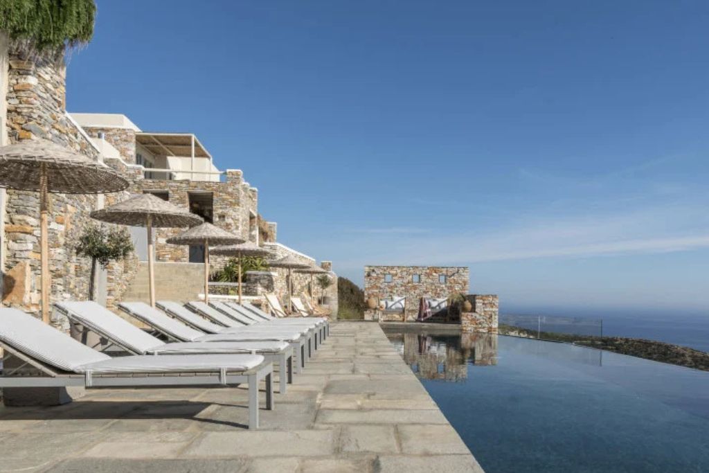 The infinity pool with loungers along the edge at the Verina Astra