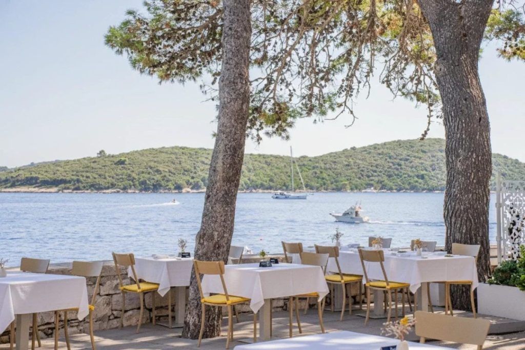 An outdoor dining area overlooking the water of the Lesic Dimitri hotel on Korcula Island.