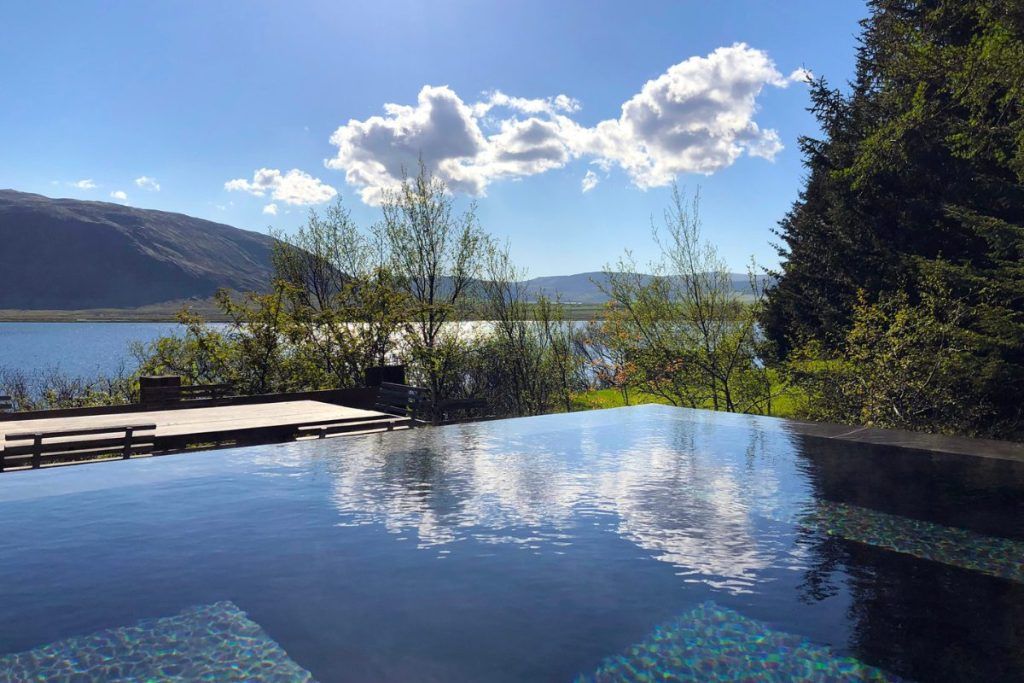 An infinity pool looking out over the waterfront in a private villa in Southern Iceland.