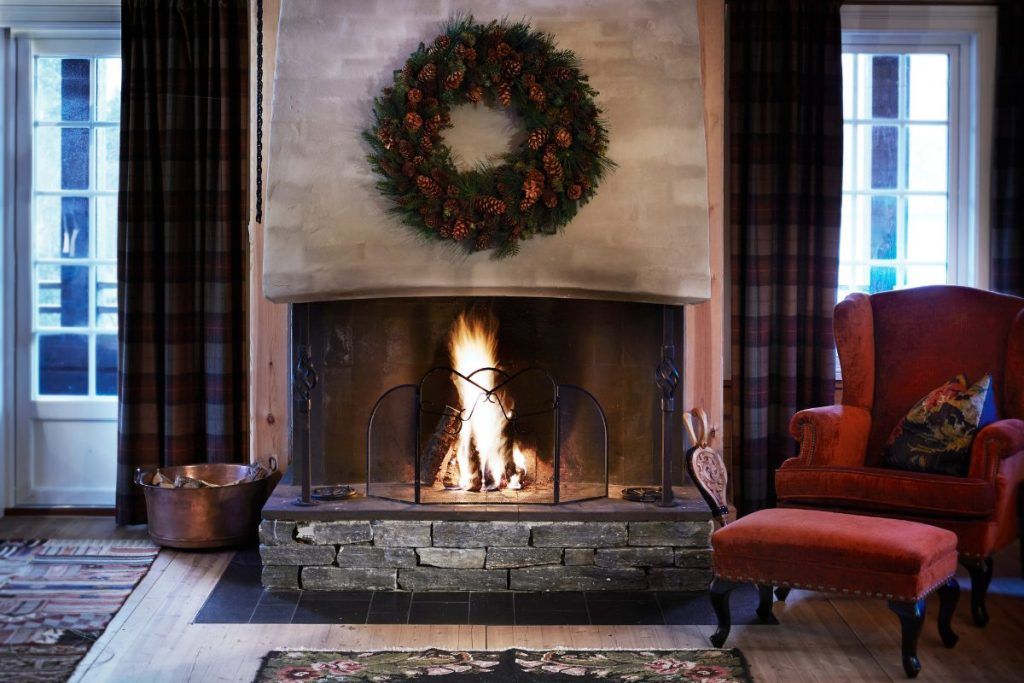A fireplace and lounge char at Storfjord Hotel.