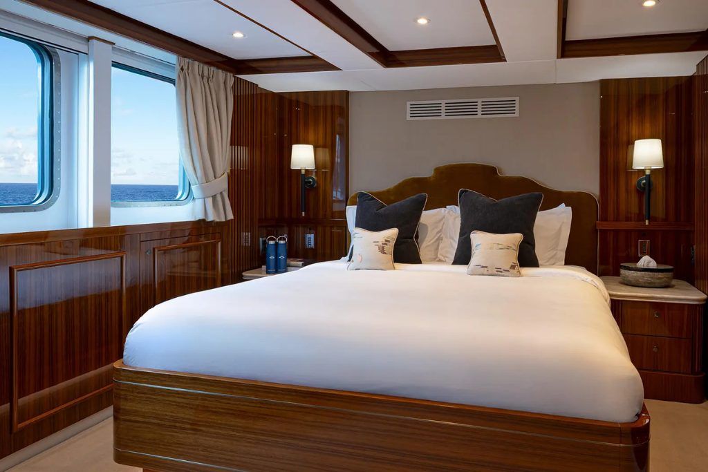 A stateroom on the Aqua Lares with a view of the King bed.