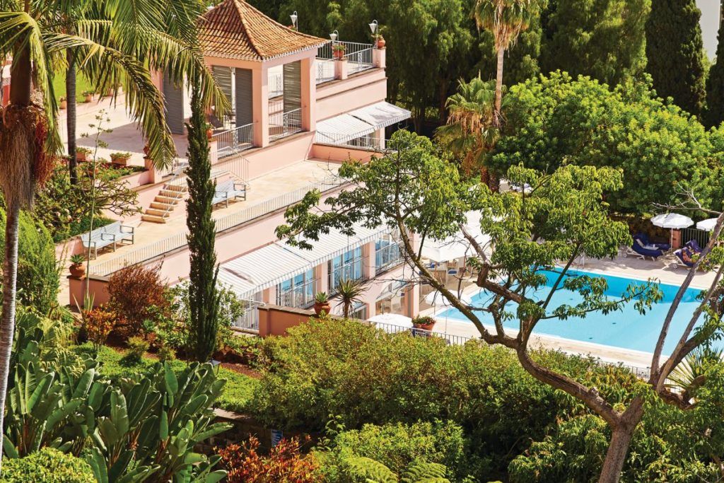 The exterior of the fitness center with a view of the pool at Belmond Reid's palace in Madiera.