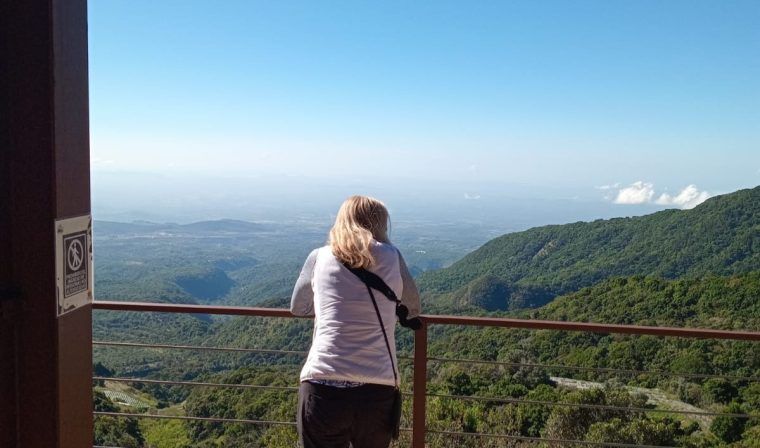 Woman looks out over green landscapes of Panama during luxury tour