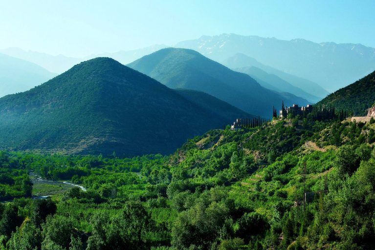 The Atlas Mountains with greenery growing on the slopes.