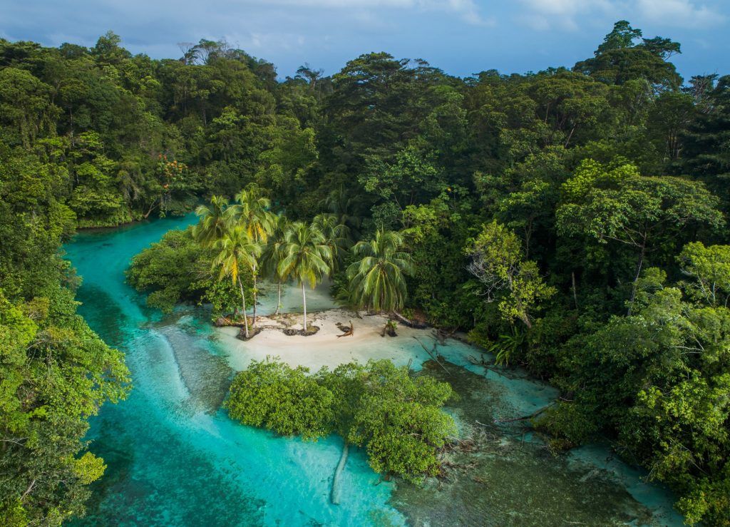 An aerial view of a small island in a jungle in Bocas del Toro.