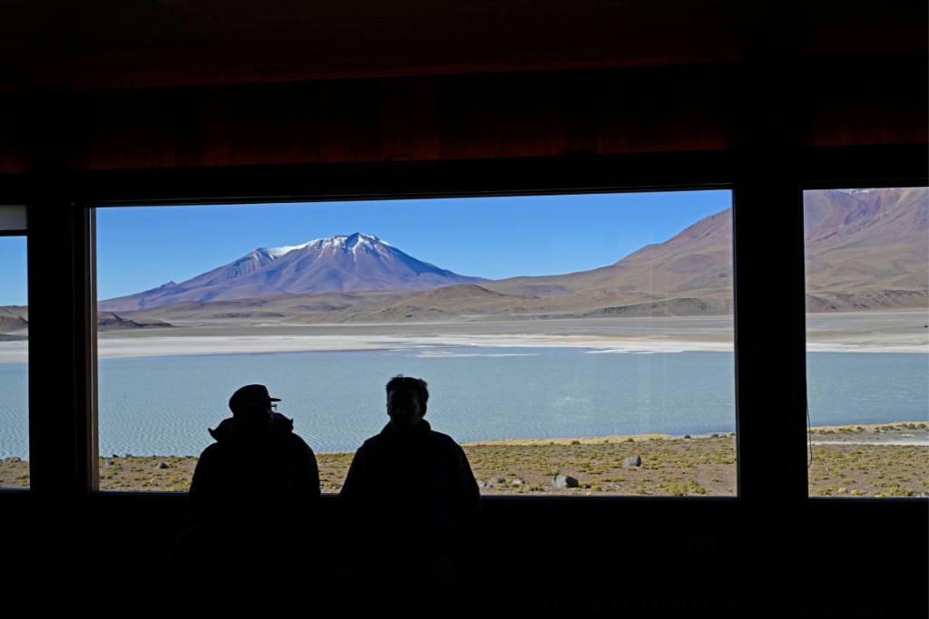 Couple admiring view of Bolivian salt flats from Ramaditas Luxury Lodge