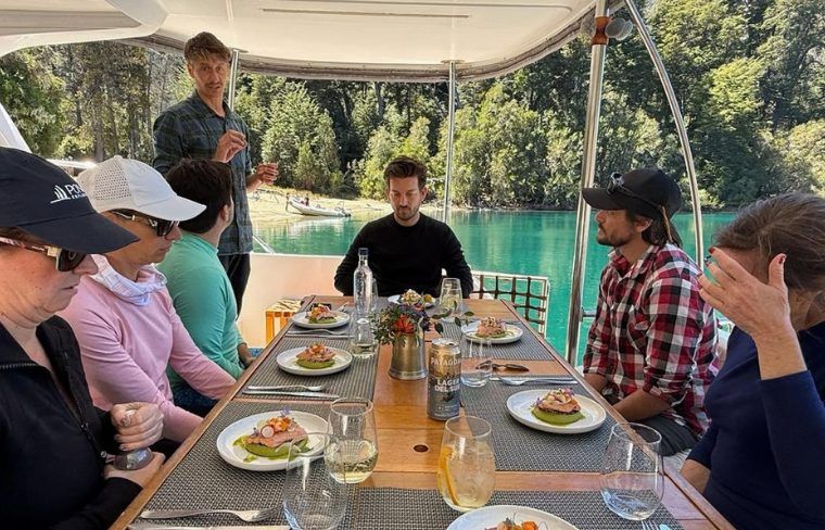 Travelers enjoying private dining experience onboard their private boat in Bariloche